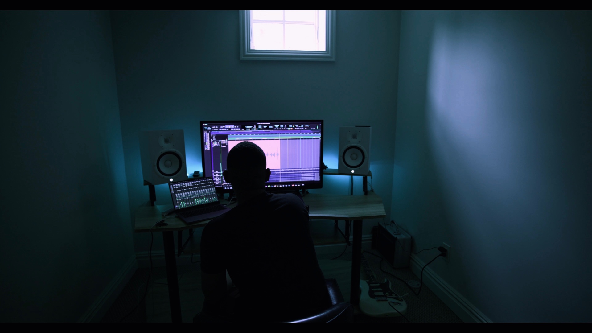 Producer working at a professional recording studio workstation